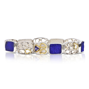 One-of-a-kind Natural Surface Lapis Bracelet.  Each link is fabricated with fused waterfall droplets accented with 18kt textured water droplets. The Bracelet features a box clasp with a faceted Tanzanite set in 18kt gold and 18kt gold water droplets. Ohara Studioss